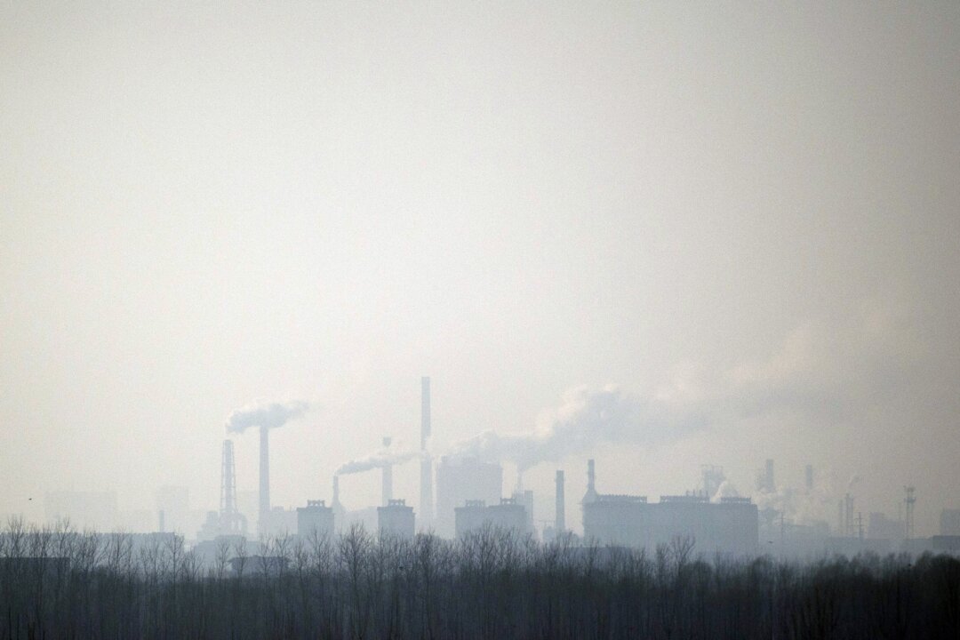 Smoke rises in the air from a chemical factory near Hengshui in northern China's Hebei Province, on Dec. 22, 2014. Many men have died from cancer in a village in southern China surrounded by dozens of factories emitting high levels of pollutants. (Fred Dufour/AFP/Getty Images)