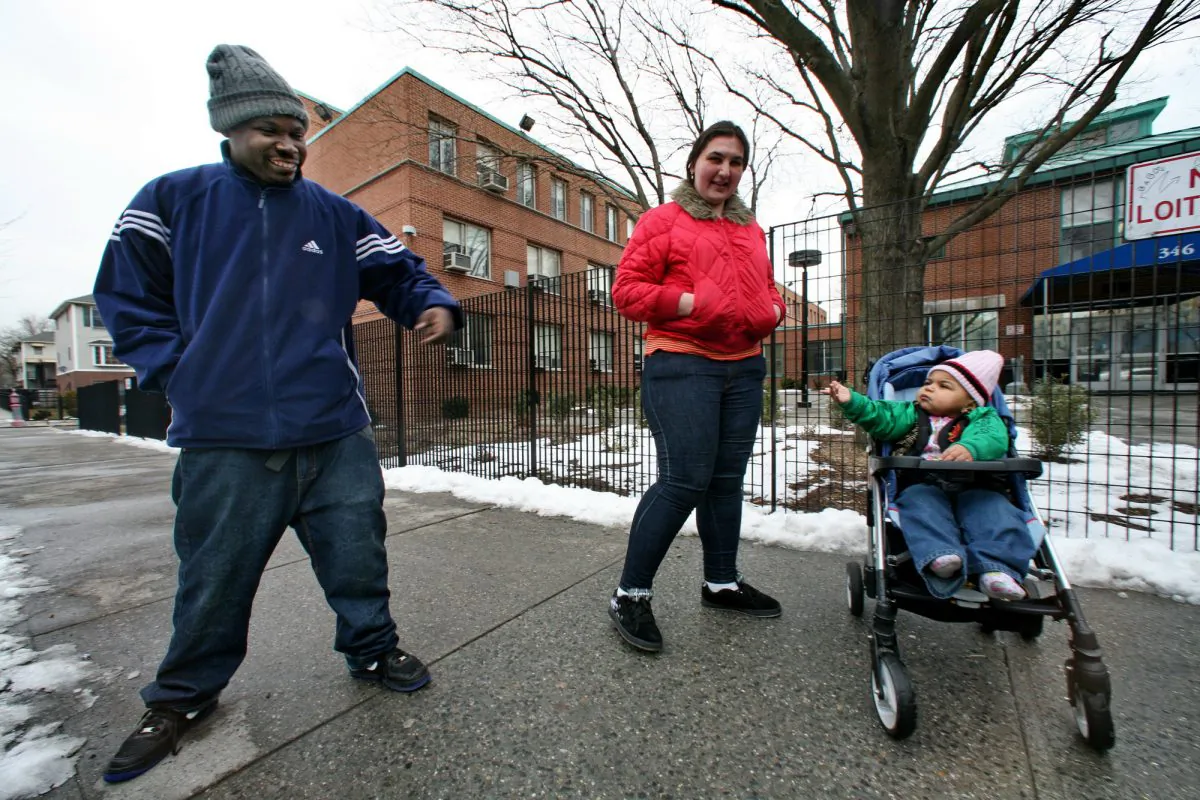 Mark and Galina Turner, and their son, Nareem, 18 months, arrive at the city's intake center for homeless families in the Bronx borough of New York, Friday March 6, 2009. The family expects help from the city to find a home after their recent eviction from an apartment, unable to pay rent from Galina's salary as a security guard. (AP Photo/Bebeto Matthews)