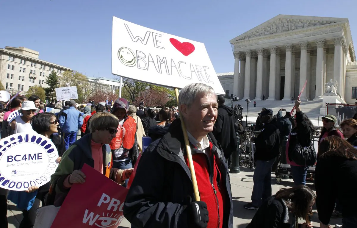 Supports of Obamacare rally in front of the Supreme Court before it ruled in favor of the individual mandate in Washington DC on March 27, 2012 (AP Photo/Charles Dharapak)