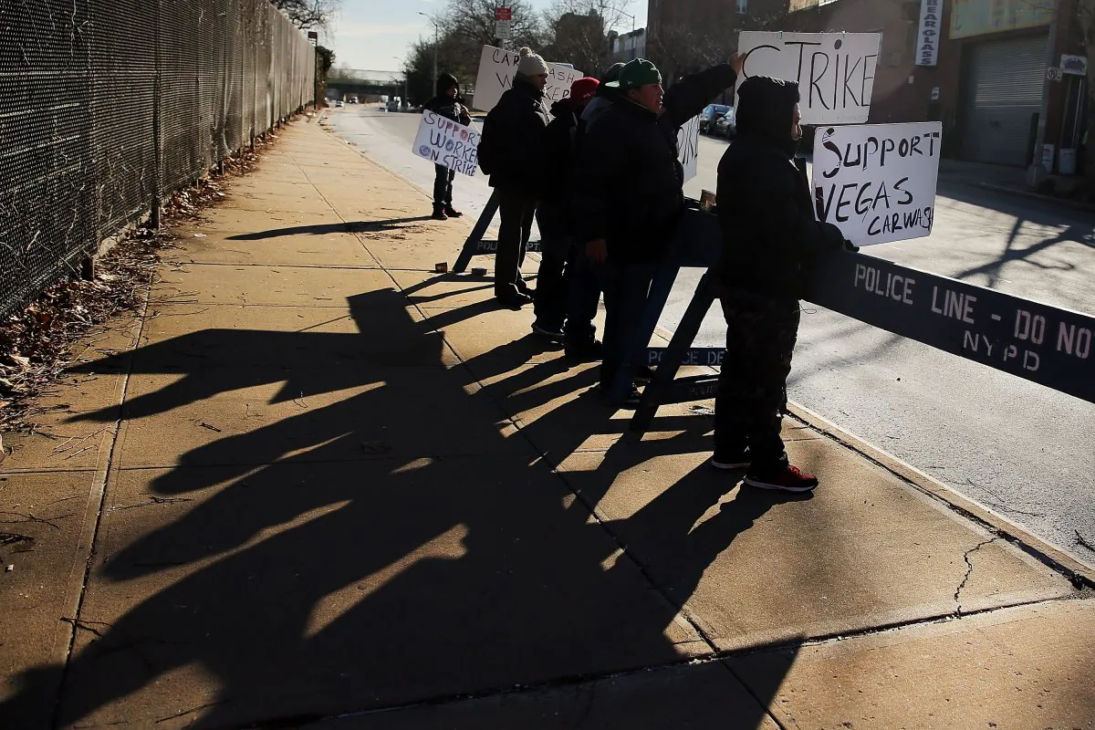 Workers from the Vegas Auto Spa stand on a picket line in front of the Brooklyn car wash in New York on Jan. 20, 2015. (Spencer Platt/Getty Images)