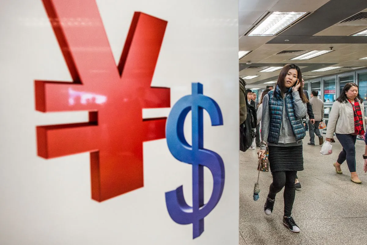 Chinese yuan (L) and U.S. dollar symbols displayed in a shop in Hong Kong. (Philippe Lopez/AFP/Getty Images)