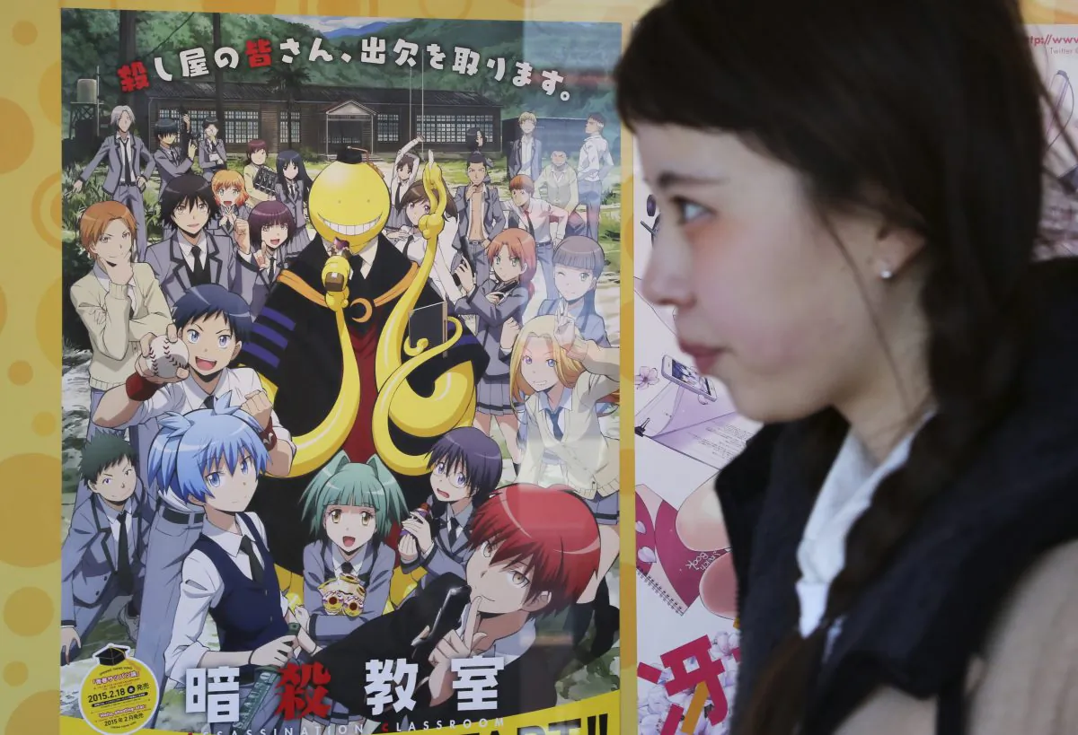 A woman walks past a poster of animation "Assassination Classroom" in Tokyo, Saturday, Jan. 31, 2015. (AP Photo/Koji Sasahara)
