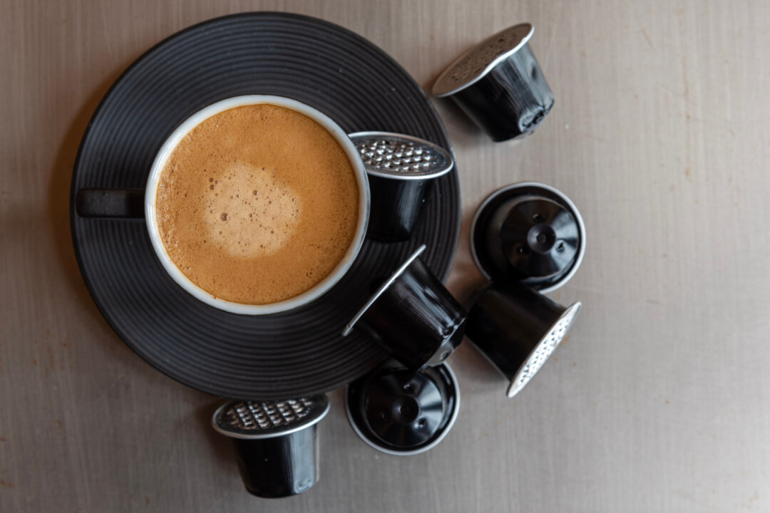 Espresso coffee cup with wasted capsules.
