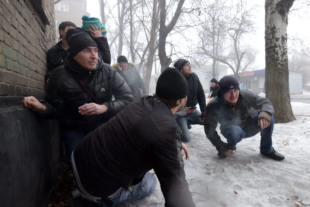People take cover during a shelling in a residential area in Donetsk's Kyibishevsky district, Ukraine, on Jan. 30, 2015. (Dominique Faget/AFP/Getty Images)