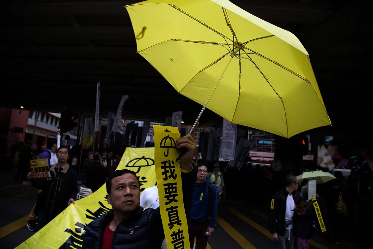 A man holds a yellow umbrella during tens of thousands of protesters march for the real universal suffrage on Feb. 1, 2015 in Hong Kong. (Lam Yik Fei/Getty Images)