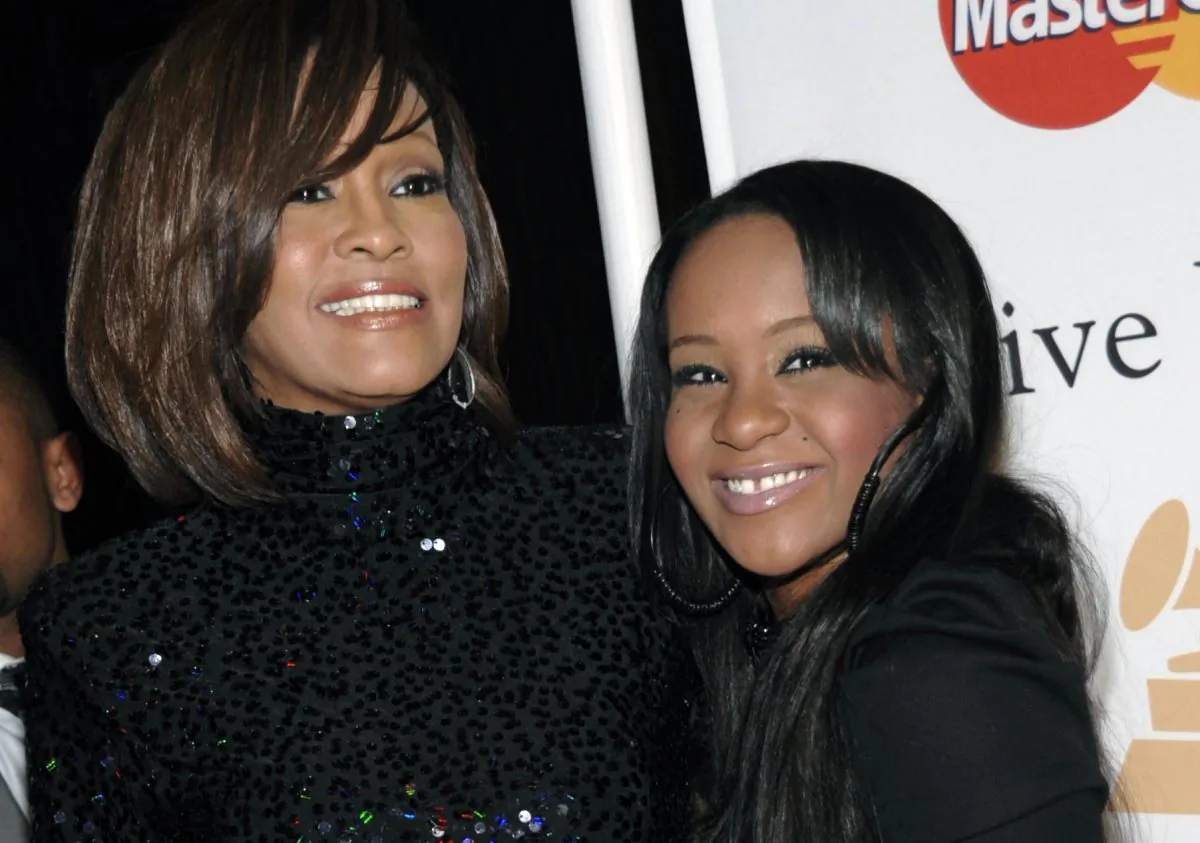 In this Feb. 12, 2011, file photo, singer Whitney Houston, left, and daughter Bobbi Kristina Brown arrive at an event in Beverly Hills, Calif.  (AP Photo/Dan Steinberg)