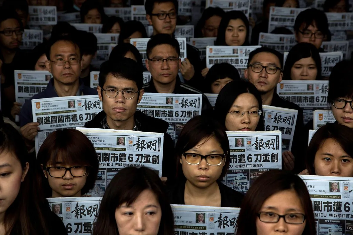 Staff members of Ming Pao hold a tribute for former chief editor Kevin Lau, who was stabbed, outside the Ming Pao office on Feb. 27, 2014 in Hong Kong. (Lam Yik Fei/Getty Images)