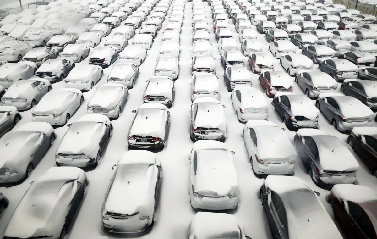 Cars are covered by snow in parking lot at O'Hare International Airport on Sunday, Feb. 1, 2015, in Chicago. The first major winter storm of the year is bearing down on the Chicago region, bringing with it blizzard conditions of heavy snow and strong winds. Numerous Chicago-area attractions are closed, more than 1,100 flights have been canceled at Chicago's airports and snow-covered roads are making travel treacherous. (AP Photo/Nam Y. Huh)