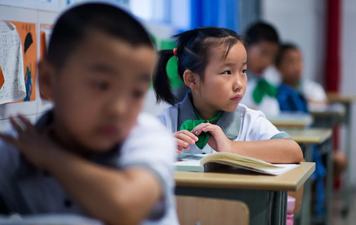 Seven year old Wei Yueran (front L), who also has the English name Harney, attends a Chinese class as a classmate (C) looks on at the Jinqao Center Primary School in Shanghai on September 1, 2014. After spending one year in the US, Yueran has joined the second class of the Jinqao Center Primary School in Shanghai's Pudong district. The Shanghai Education Commission recently announced the opening of 50 new public schools in the city, according to local news.
(Johannes Eisele/AFP/Getty Images)