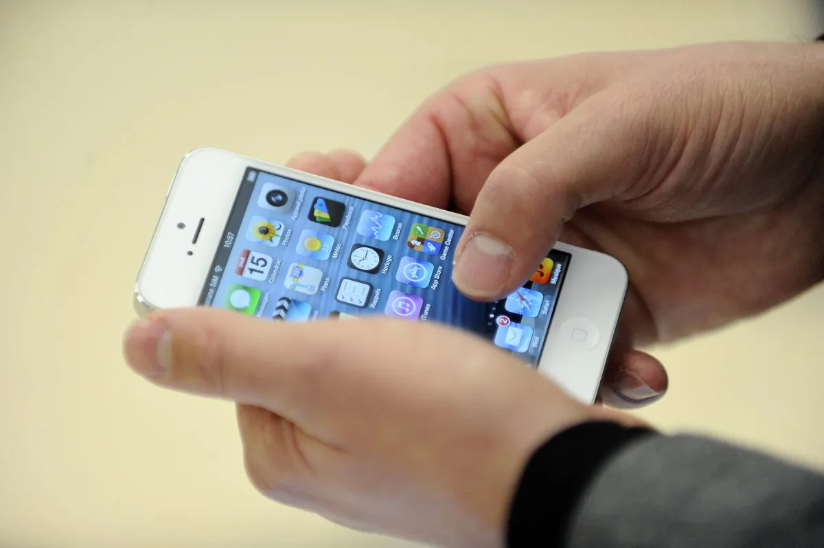 Smartphones are alleged to fetch around $3,500 in California’s prisons, an iPhone 5 shown here on Nov. 15, 2012. (Jean-Sebastien Evrard/AFP/Getty Images)
