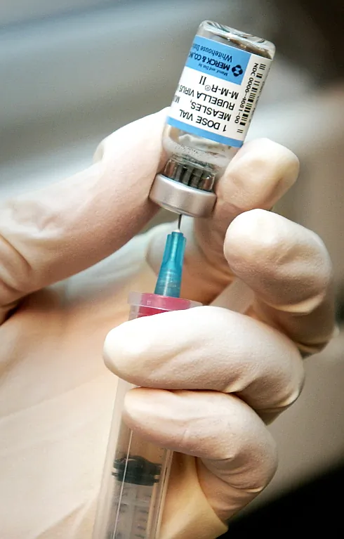A registered nurse at the Wichita Clinic in Wichita, Kan., draws a dose of mumps, measles, rubella, or MMR vaccine in this file photo. (AP Photo/The Wichita Eagle, Mike Hutmacher, File)