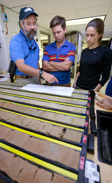 Penman (the lead author) offered this image of himself (center), Richard Norris (Scripps) and Pincelli Hull (Yale) inspecting sediment cores from the PETM while aboard a scientific drilling vessel. Photo credit Donald Penman.