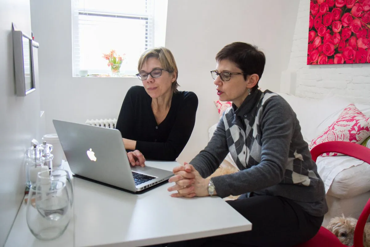Liz Gessner (L) organizes her tax documents with professional organizer Sharon Lowenheimat at Gessner’s home in Park Slope, Brooklyn, on Jan. 22. As life gets more complicated, more people are hiring professional organizers for various aspects of life. (Amelia Pang/Epoch Times)