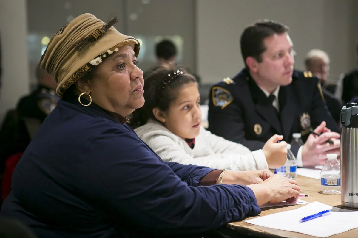 The Rev. Georgette Morgan-Thomas moderates a discussion at her roundtable on how to improve police–community relations, in Washington Heights, Manhattan, on Feb. 2. To her left is Capt. Michael Baker, whom she works closely with. (Samira Bouaou/Epoch Times)
