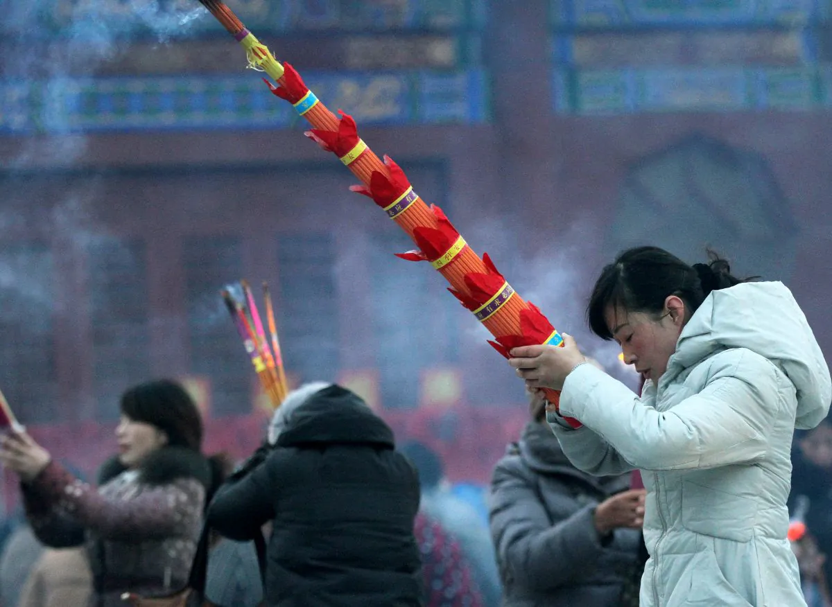 People light incense during the Laba Festival at Ciyunchansi Temple on Jan. 27, 2015 in Huai'an, Jiangsu Province, China. Enthusiasm for fortune telling and Feng Shui is common in Chinese communist officialdom as Party members lose faith in communism. (ChinaFotoPress/Getty Images)