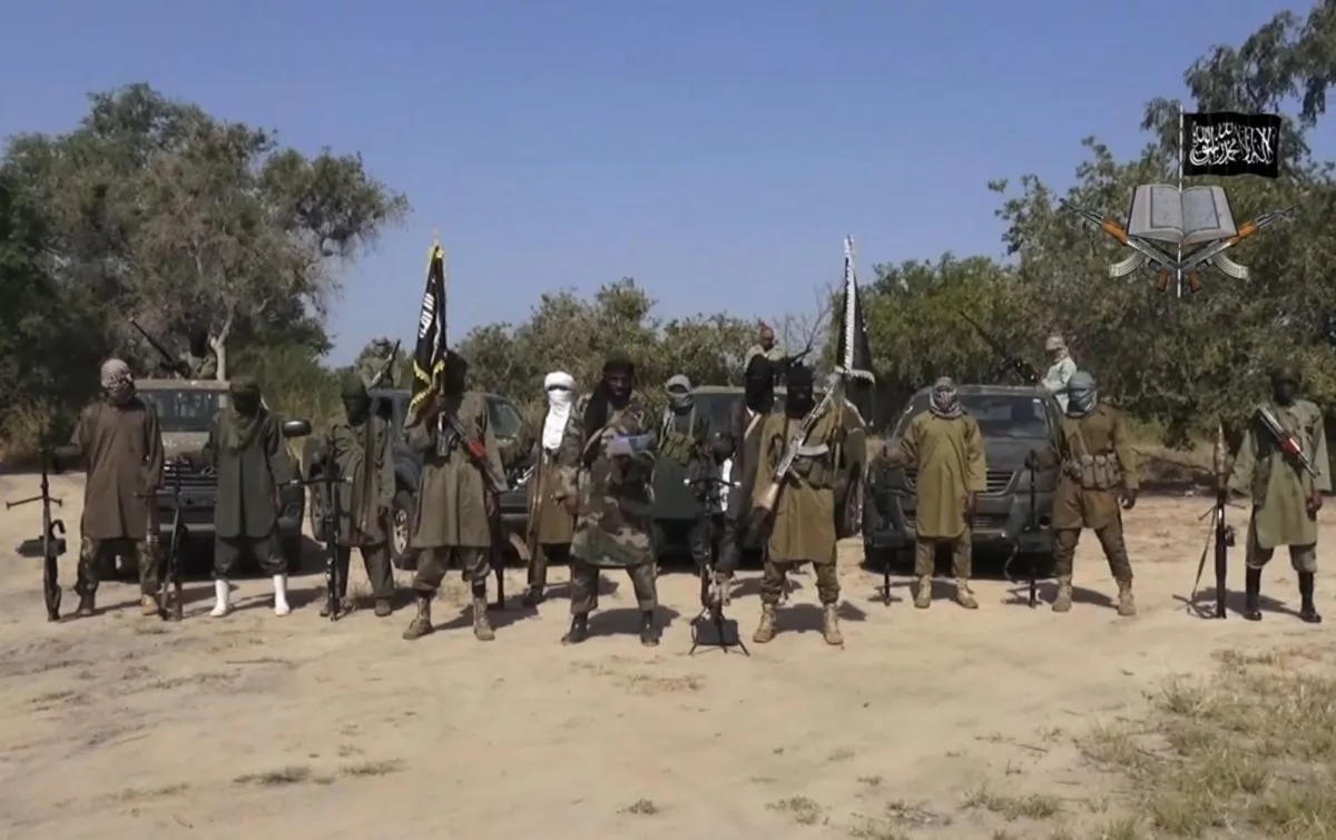 This video-image released on Oct. 31, 2014, by Boko Haram shows Abubakar Shekau (C), the leader of Nigeria's Islamic extremist group. (AP Photo/Boko Haram)