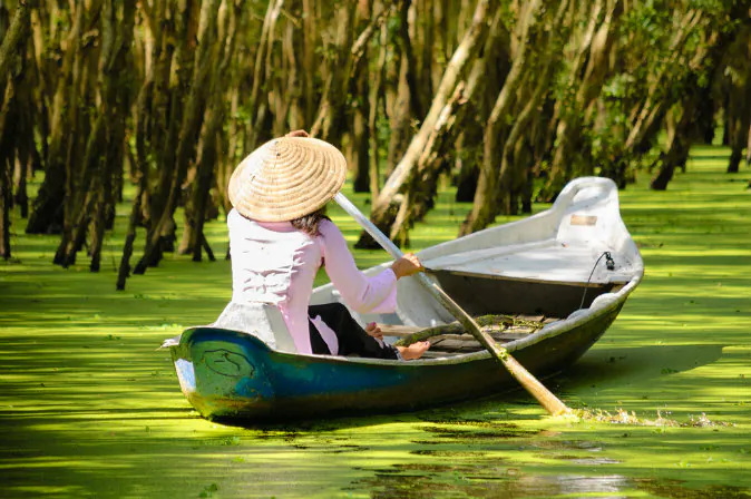 Woman paddling in the Tra Su flooded forest, Mekong Delta, An Giang, Vietnam via Shutterstock*
