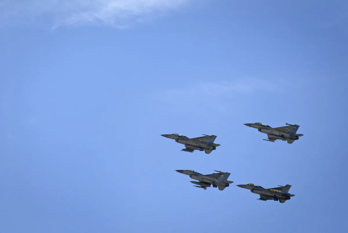 Jordanian Air Force fighter jets fly during the funeral of slain Jordanian pilot, Lt. Muath al-Kaseasbeh, at his home village of Ai, near Karak, Jordan, on Feb. 4, 2015. (AP Photo/Nasser Nasser)
