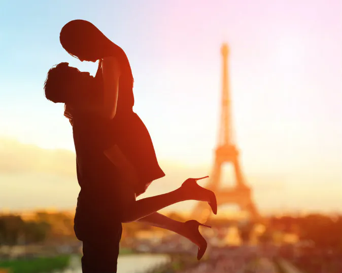 A silhouette of romantic lovers with eiffel tower in Paris via Shutterstock*