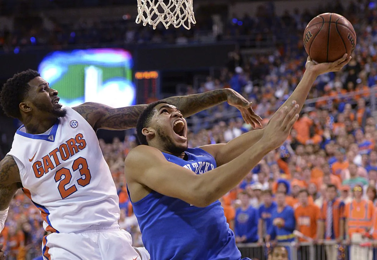 Florida forward Chris Walker (23) pressures Kentucky forward Karl-Anthony Towns (12) during the first half of an NCAA college basketball game in Gainesville, Fla., Saturday, Feb. 7, 2015. Kentucky defeated Florida 68-61. (AP Photo/Phil Sandlin)