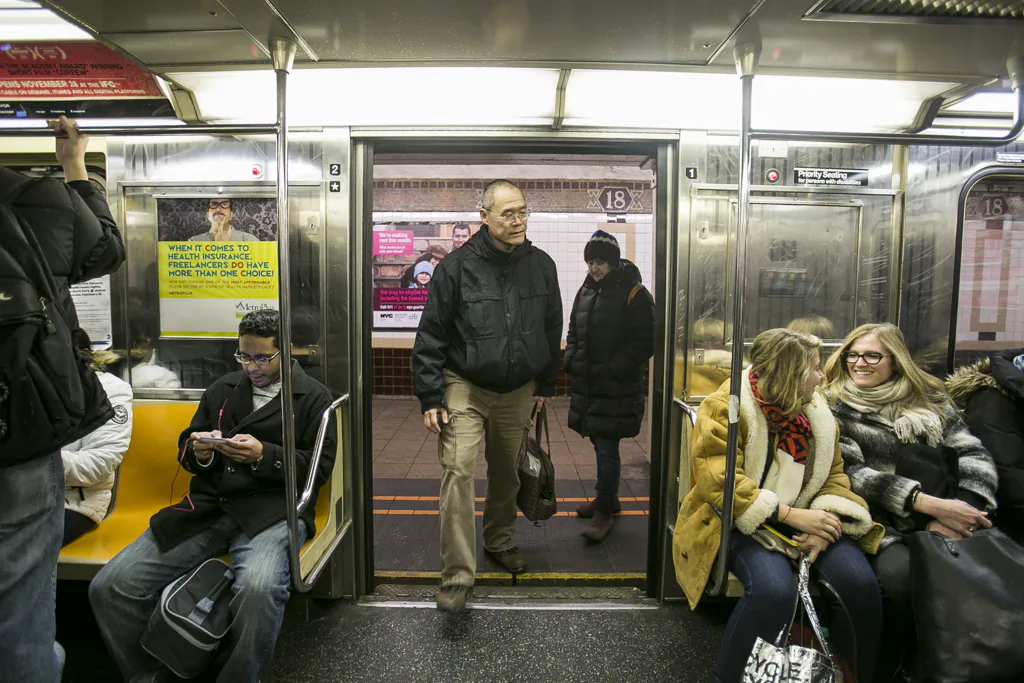 A man enters the 1 train at the 18th St. subway station in Manhattan, New York, on Feb. 1, 2015. Even though subway cars are teeming with microbial life, it's not something New Yorkers need to worry about, according to new research. (Samira Bouaou/Epoch Times)