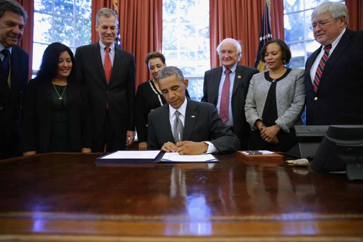 President Barack Obama (C) signs the signed the Improving Medicare Post Acute Care Transformation Act of 2014 (IMPACT Act) at the White House in Washington, D.C., on Oct. 6, 2014. (Chip Somodevilla/Getty Images)