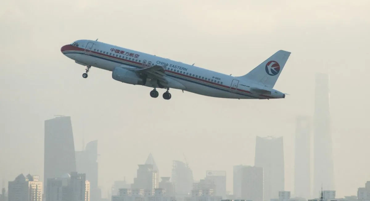 A plane from Chinese airline China Eastern departs from Hongqiaou Airport in Shanghai in front of the skyline on February 8, 2015. UniGroup Relocation, an international moving company, recently conducted a study showing that twice as many expatriates left China than arrived in 2014. (Johannes Eisele/AFP/Getty Images)