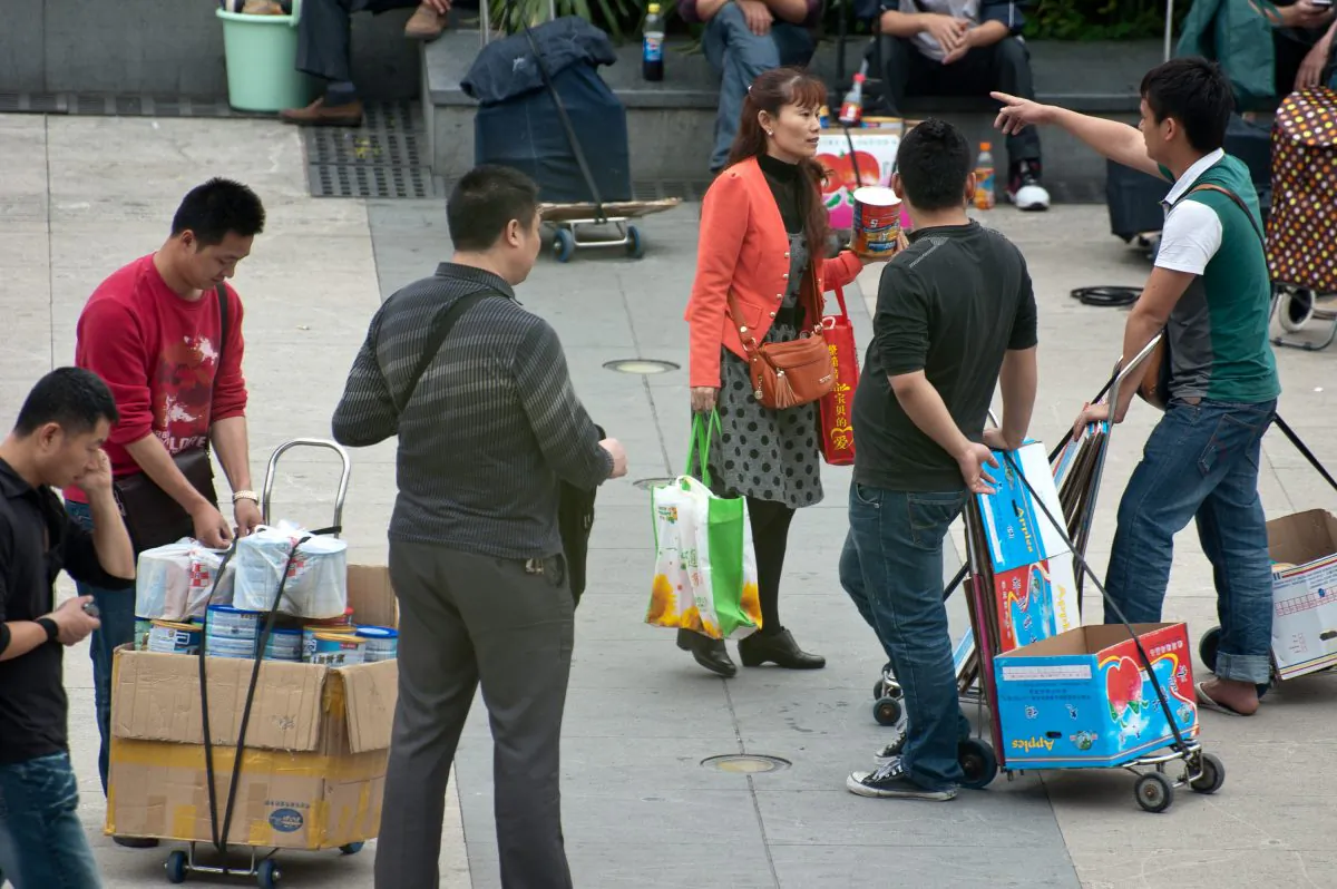 Dealers wait on the square to buy imported milk formula from people coming from Hong Kong at Luohu Control Port in Shenzhen, south China's Guangzhou province on April 13, 2013. (STR/AFP/Getty Images)