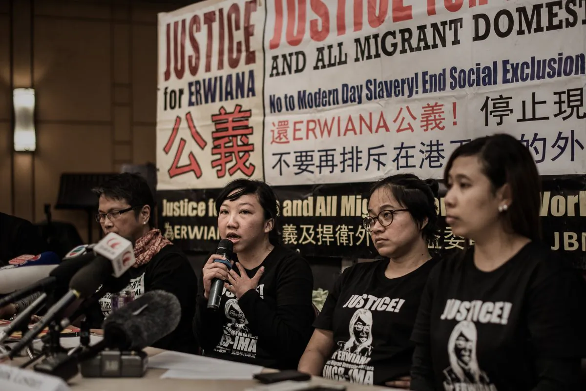 Indonesian former maid Erwiana Sulistyaningsih (C) answers questions during a press conference in Hong Kong on February 10, 2015 after her employer was convicted of beating her in a "torture" case that sparked international outrage and spotlighted the plight of migrant domestic workers in the Middle East and Asia. (Philippe Lopez/AFP/Getty Images)