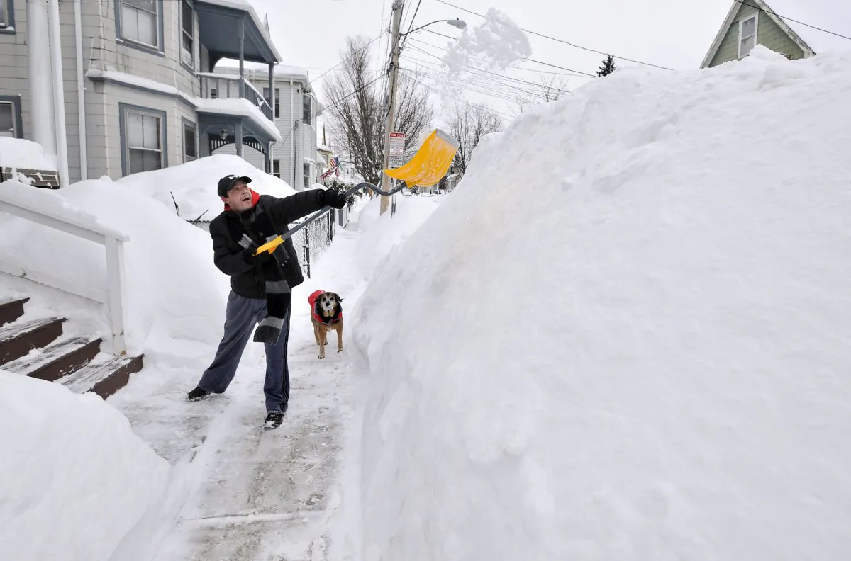 A Boston-area resident shoveling snow. (AP Photo/Josh Reynolds)
