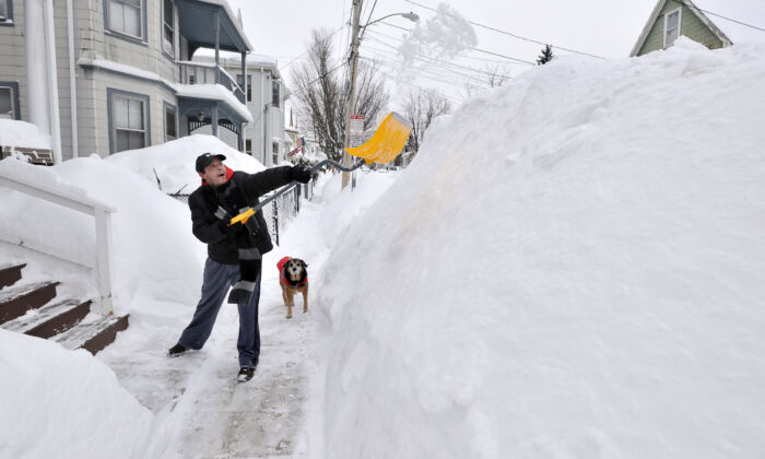 A Boston-area resident shoveling snow. (AP Photo/Josh Reynolds)