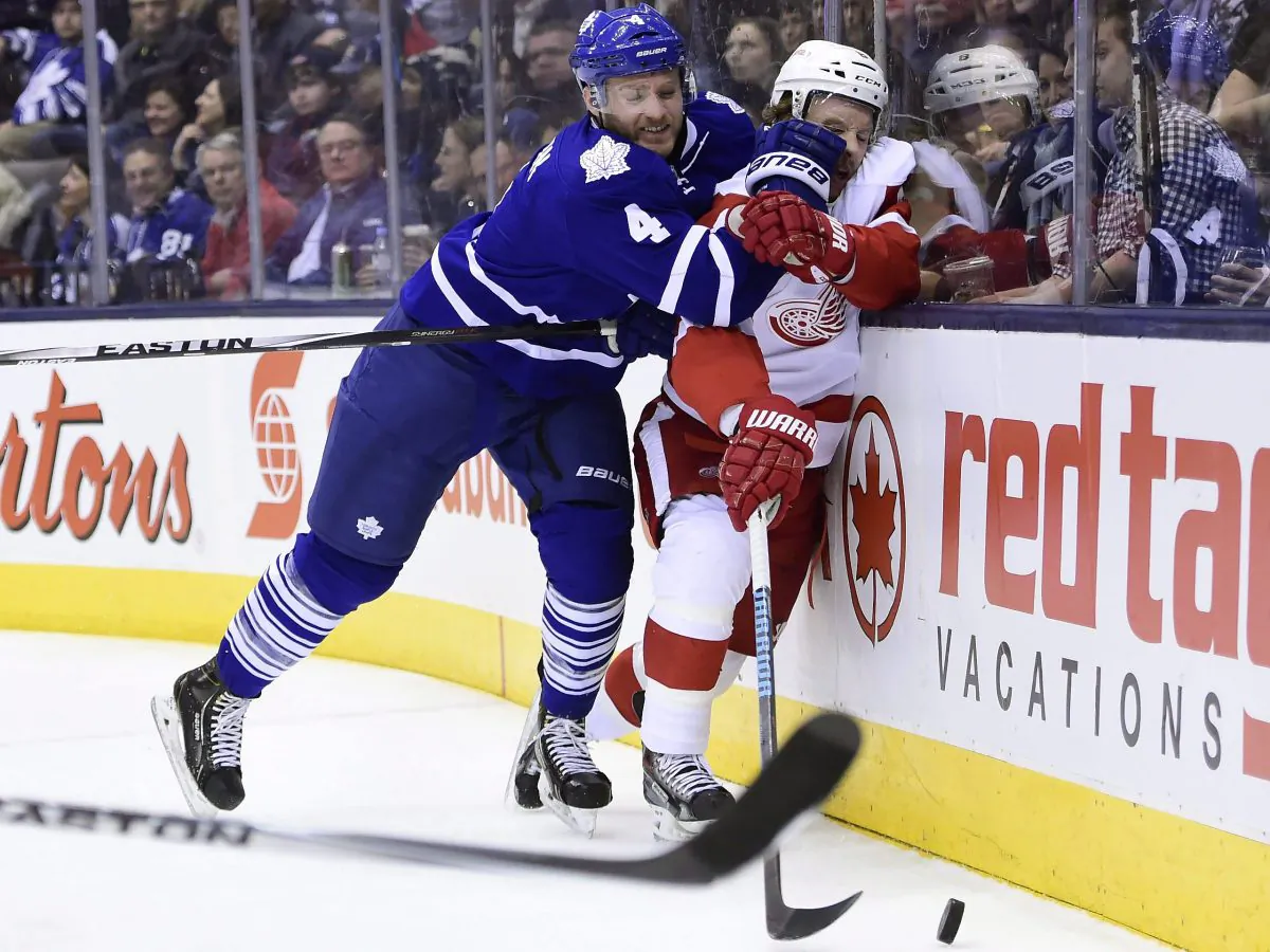 Toronto Maple Leafs' Cody Franson hits Detroit Red Wings' Justin Abdelkader at the Air Canada Centre in Toronto on Nov. 22, 2014. (The Canadian Press/Frank Gunn)