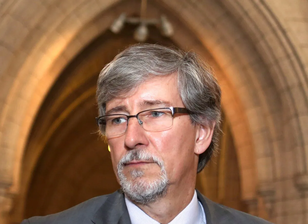 Privacy Commissioner Daniel Therrien prepares to appear at the Commons Human Rights committee on Parliament Hill June 10, 2014. Therrien has raised concerns about the government’s anti-terrorism bill but has yet to pass final judgement. (The Canadian Press/Fred Chartrand)