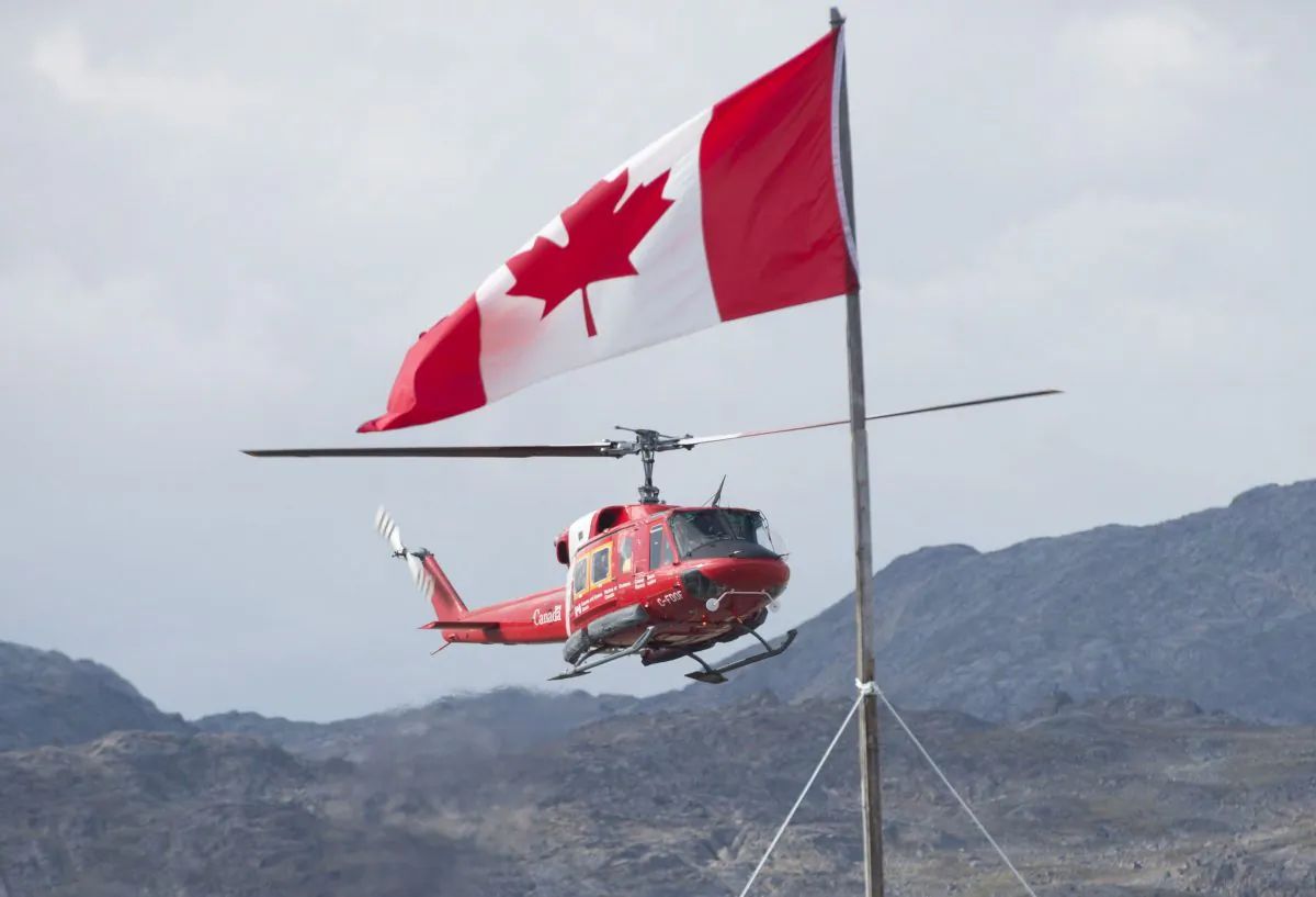 A Canadian Coast Guard helicopter makes an approach to land at the military camp on Baffin Island on Aug. 26, 2014. (Adrian Wyld/The Canadian Press)