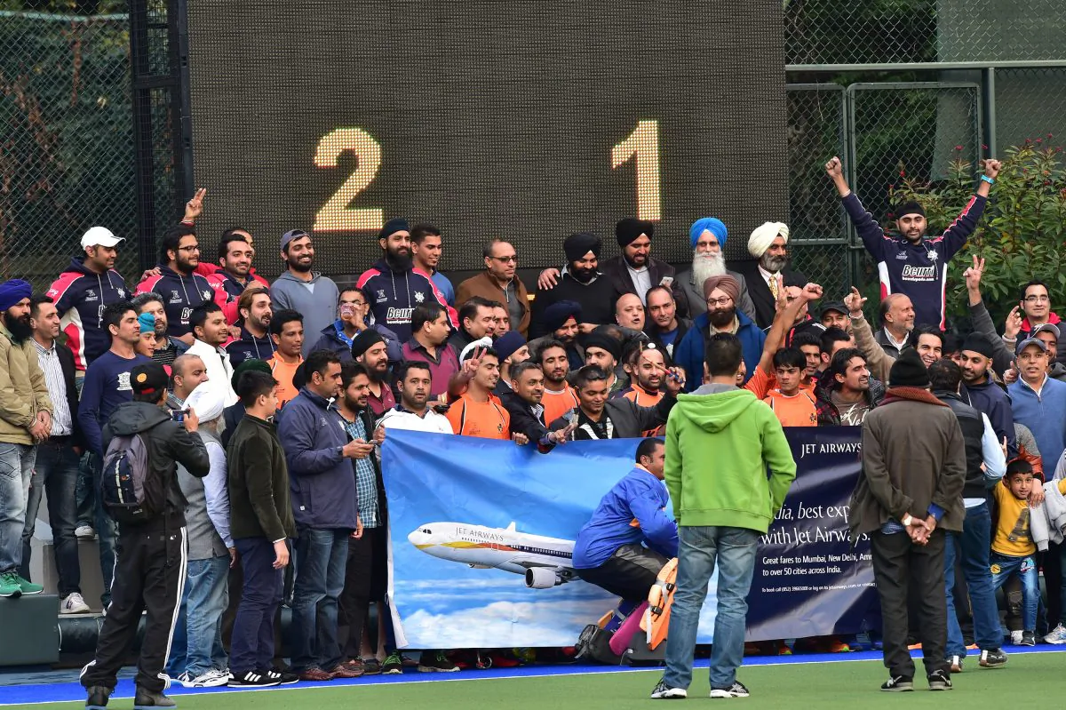 Singh Sabha Sports Club (SSSC-A) and supporters celebrate winning their first HKHA Premiership title after winning their match against Khalsa–A 2-1 at King’s Park on Sunday Feb 8, 2015. (Bill Cox/Epoch Times)
