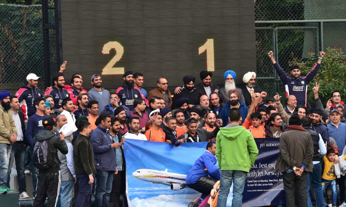 Singh Sabha Sports Club (SSSC-A) and supporters celebrate winning their first HKHA Premiership title after winning their match against Khalsa–A 2-1 at King’s Park on Sunday Feb 8, 2015. (Bill Cox/Epoch Times)