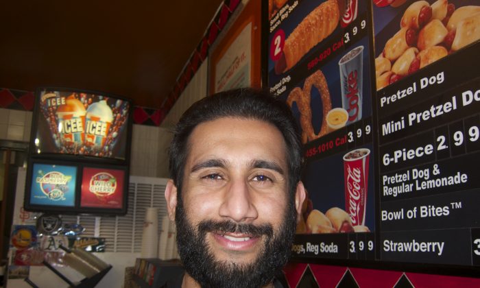 Osman Khan, of Hayward, commutes over forty miles to his cashier job at Pretzelmaker because jobs are hard to come by in his city.  (Chun Lee/Epoch Times)