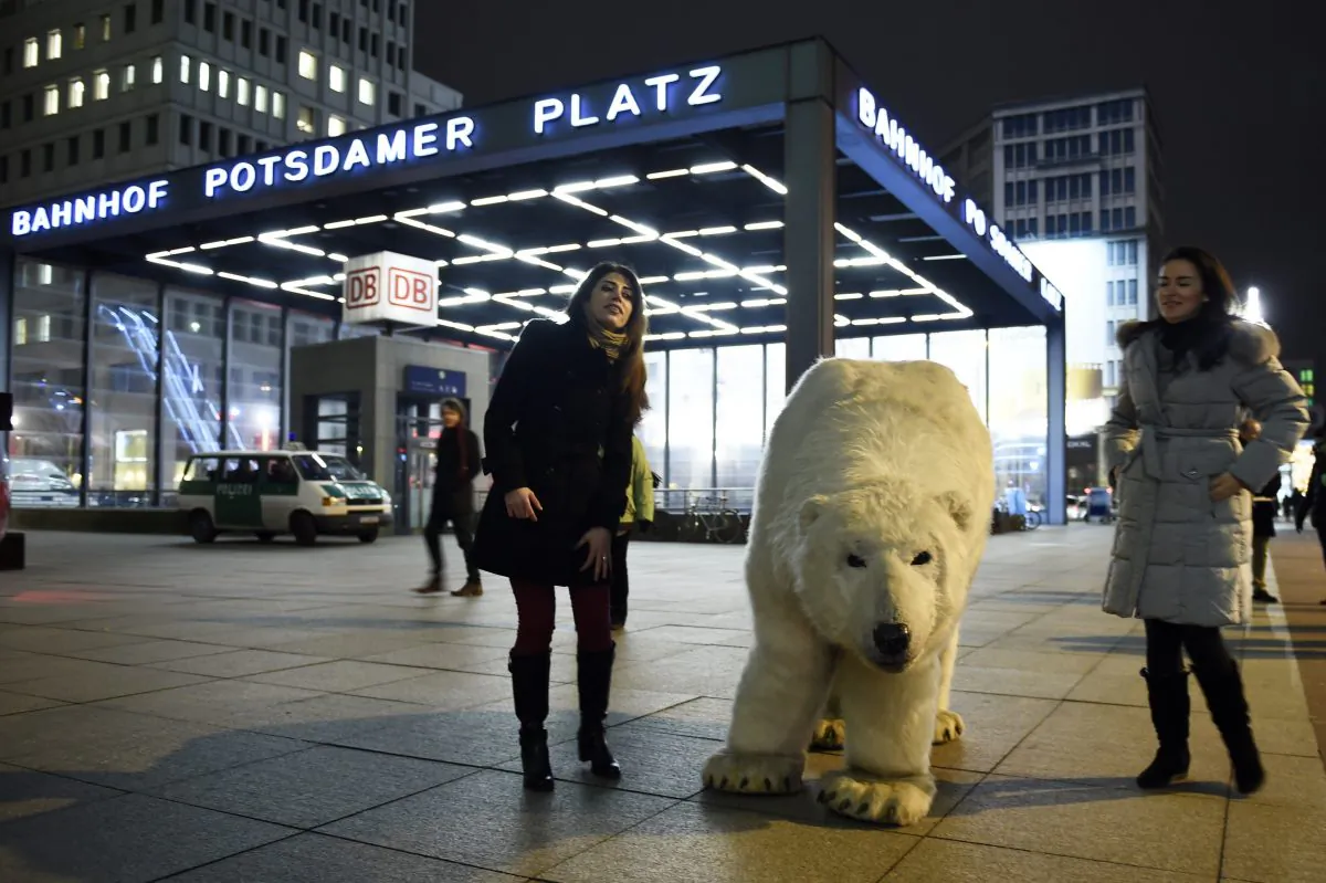 Supporters of Greenpeace pose next to a mock polar bear during a protest action in Berlin, on Feb. 10, 2015, against drilling for oil in the Arctic. (Odd Andersen/AFP/Getty Images)
