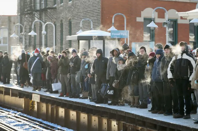 Passengers heading into downtown wait on an "L" platform for the train to arrive in below zero temperatures on January 7, 2014 in Chicago, Illinois. (Photo by Scott Olson/Getty Images)