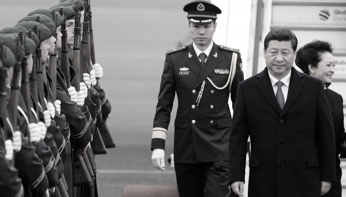 Chinese regime leader Xi Jinping (C) and his wife Peng Liyuan arrive at Berlin's Tegel airport on March 28, 2014. (John Macdougall/AFP/Getty Images)