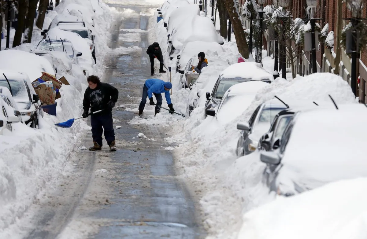 People work to shovel snow-covered cars out in Boston's Charlestown section, on Jan. 28, 2015. (AP Photo/Elise Amendola)