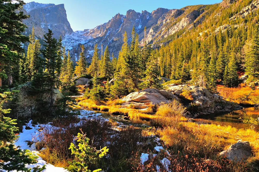 Rocky Mountain National Park in fall with snow and mountains in background, Colorado via Shutterstock*