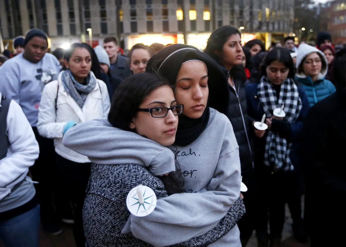 N.C. State University sophomore Firdaws Chahrour, right, and Danyah Dahbour before a vigil on their school campus to remember Deah Shaddy Barakat, 23, his wife Yusor Mohammad Abu-Salha, 21, and Abu-Salha's sister, Razan Mohammad Abu-Salha, 19, on Thursday, Feb. 12, 2015.  The three were killed Tuesday evening in Chapel Hill. (Ethan Hyman/ The News & Observer/AP)