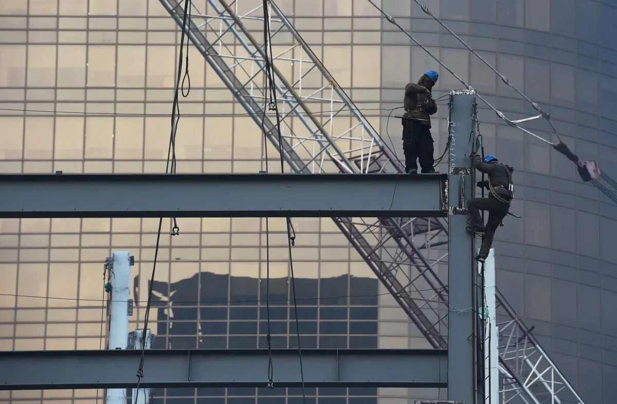 In this file photo, Chinese construction workers on Dec. 18, 2014 in central Beijing, China. On Feb. 14, State-run Xinhua news reported on several cases of faked industrial output reports in south-central China’s Hunan Province. (Kevin Frayer/Getty Images)