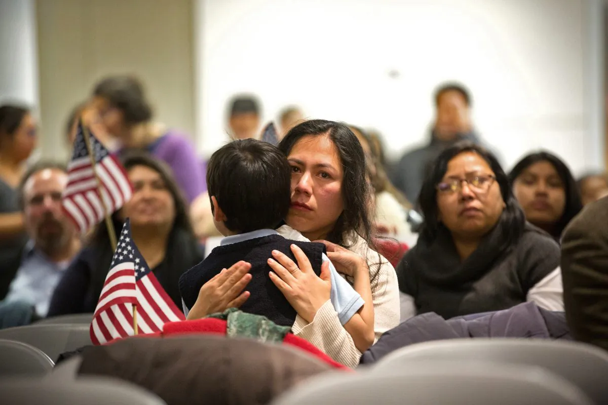 Martha Moran, holds her 6-year-old son Tonatiuh Moran, during a viewing party for President Barack Obama’s speech on immigration policy reform in New York City on Nov. 20, 2014. (Kevin Hagen/Getty Images)