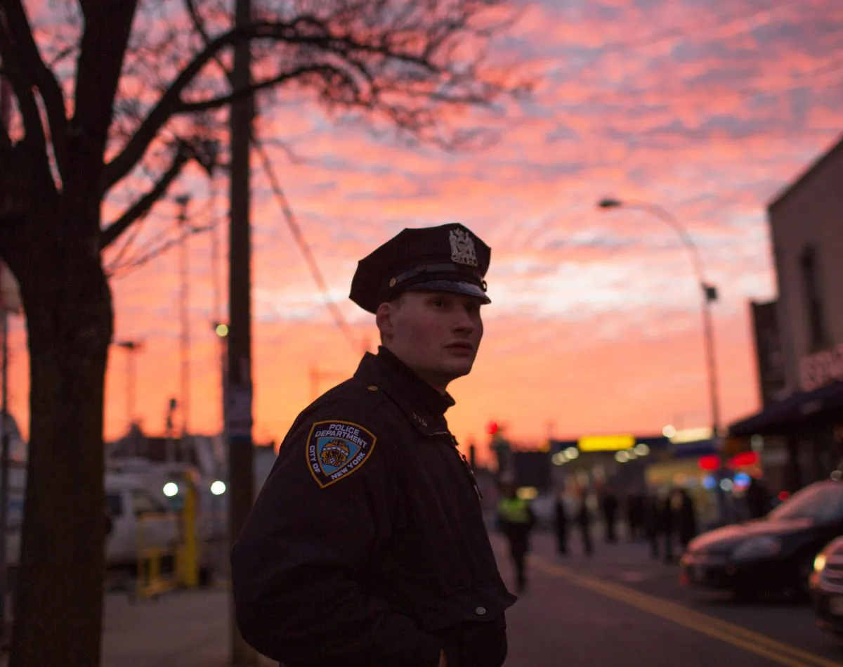 An officer directs traffic for the funeral of slain NYPD Officer Rafael Ramos, one of two officers murdered while sitting in their patrol car in an ambush in Brooklyn, New York City, in December 2014. (Kevin Hagen/Getty Images)