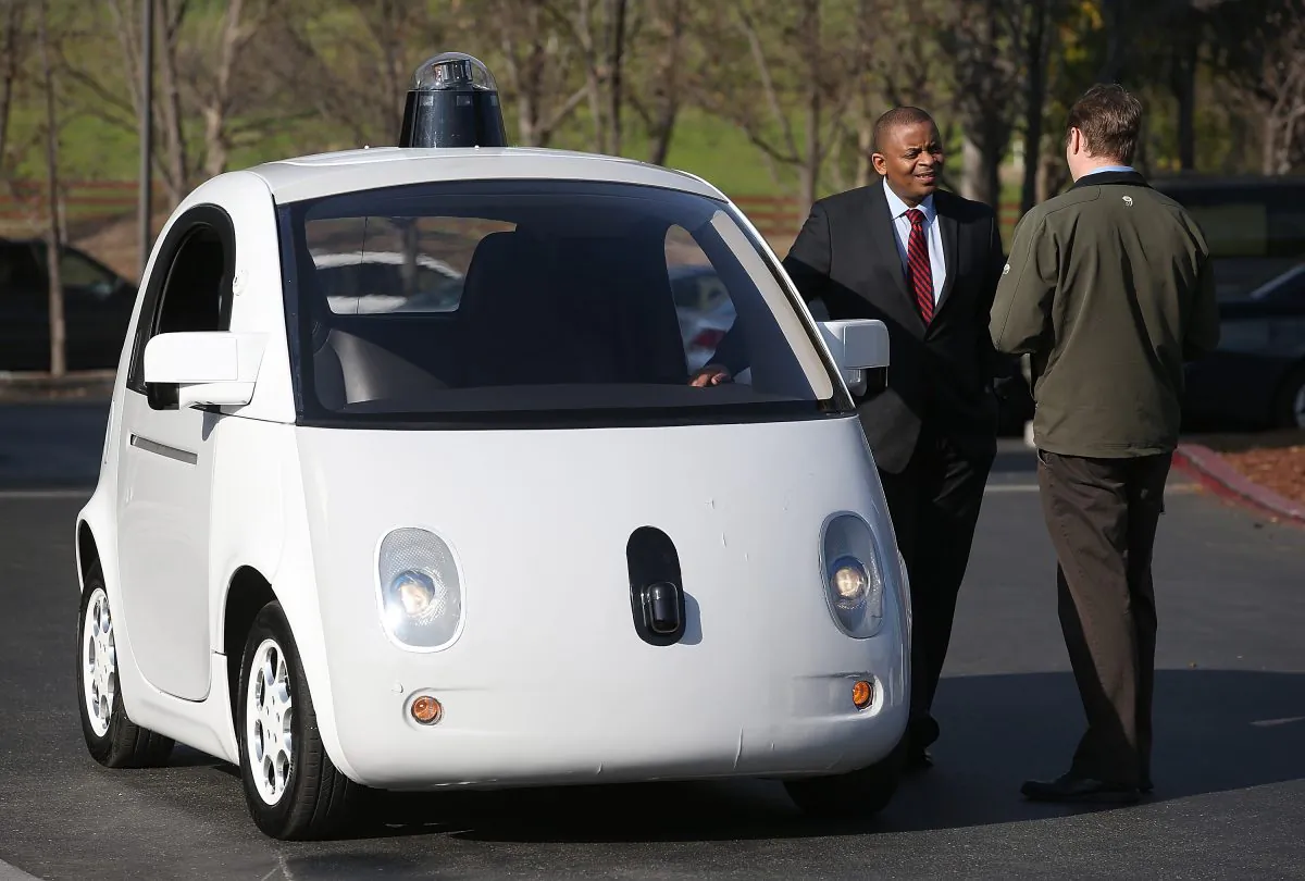 U.S. Transportation Secretary Anthony Foxx (L) inspects a Google self-driving car at the Google headquarters on Feb. 2, 2015, in Mountain View, Calif. Semi-autonomous cars are already on the market, with their capabilities continually expanding. (Justin Sullivan/Getty Images)