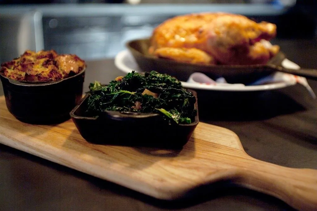 Chicken for Two With Savory Bread Pudding and Sweet and Sour Greens. (Courtesy of Almond Tribeca)