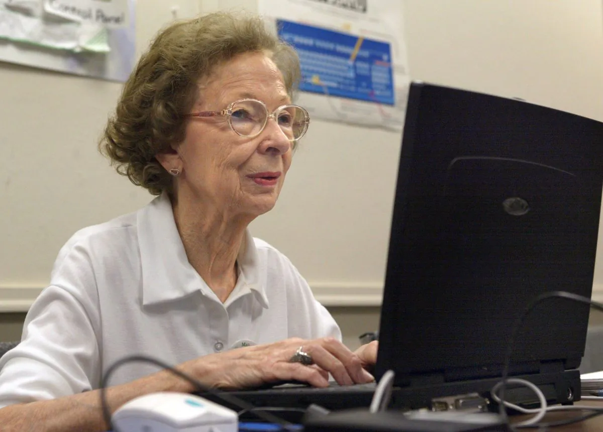 Suzette D'Hooghe, 77, works on her laptop during a computer class in Des Plaines, Illinois, July 23, 2003. A project led by a group of Ontario high school students is opening up a new world for seniors by teaching them basic computer skills. It is helping close not only the digital divide, but also the generational one. (Tim Boyle/Getty Images)