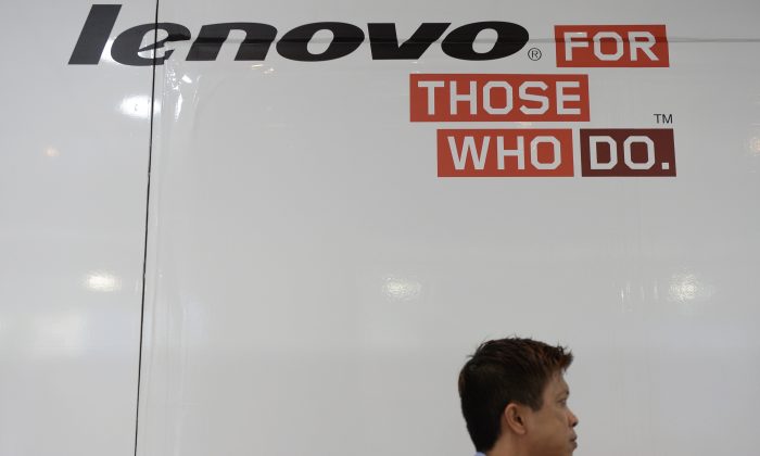 A man walks past Lenovo advertising at a computer centre in Hong Kong on August 14, 2014. (Dale de la Rey/AFP/Getty Images)